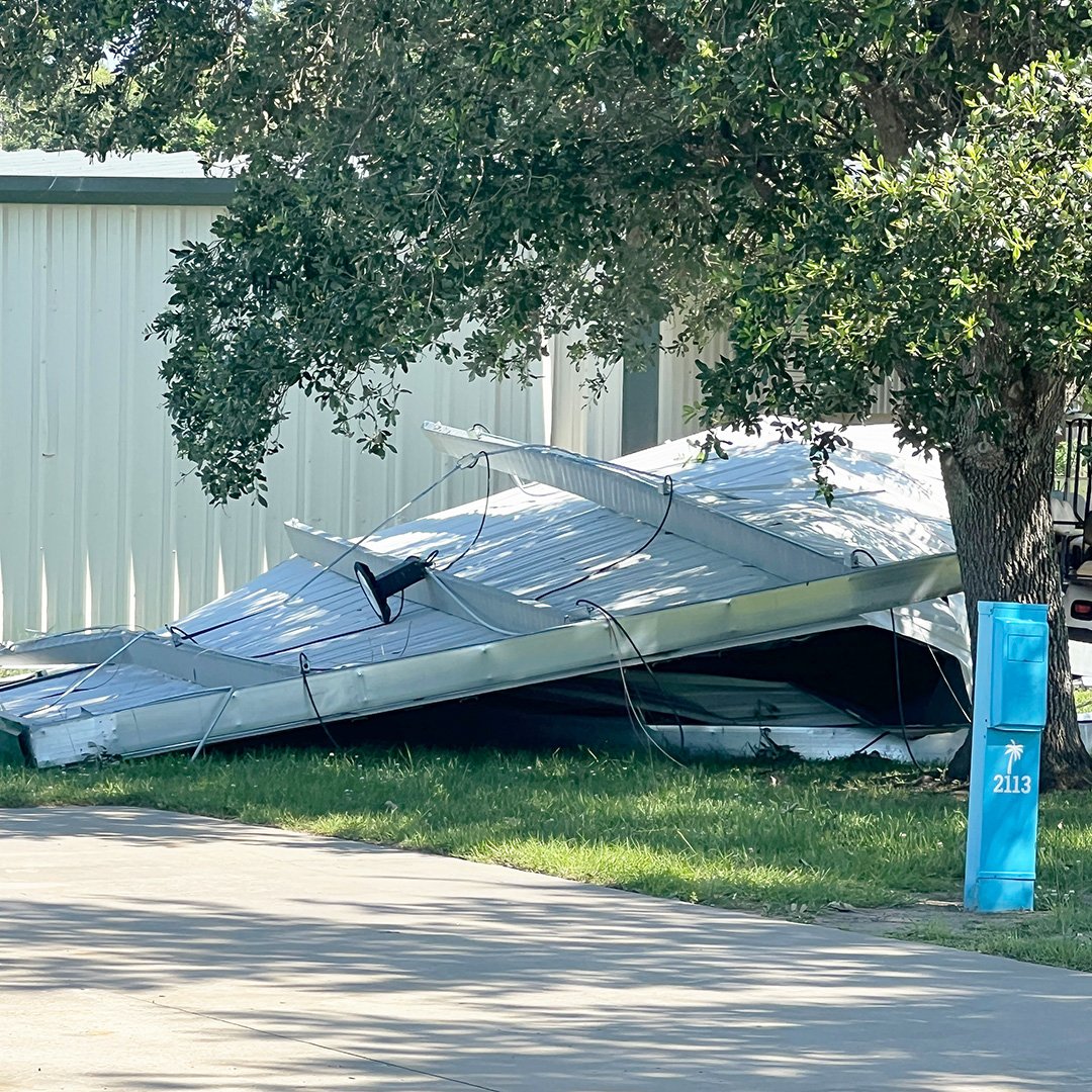 Tornado storm damage at Camp Margaritaville RV Resort in Breaux Bridge Louisiana showing sheared metal structure and debris.